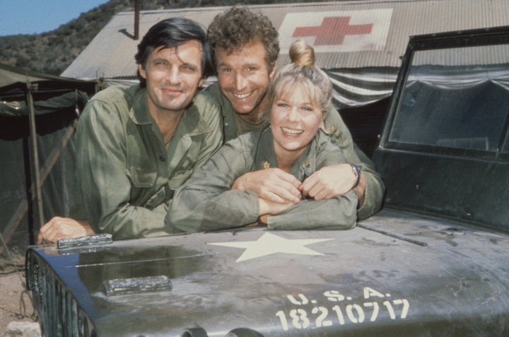 Alda is seen with fellow actors Wayne Rogers, as Captain Trapper John McIntyre, and Loretta Swit, as Major Margaret Houlihan,