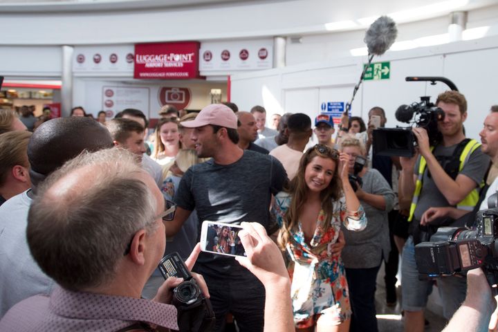 Jack and Dani were greeted by a mob of fans as they landed in the UK