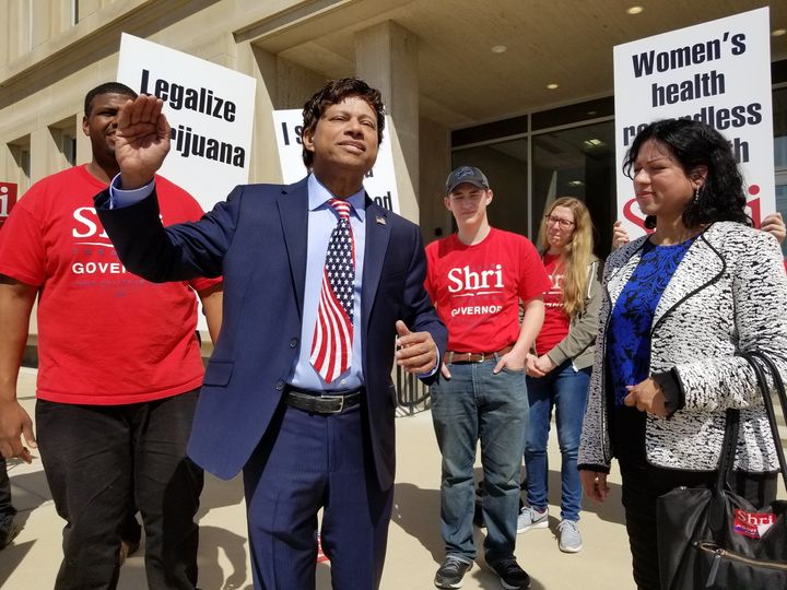 Shri Thanedar stands with supporters at a campaign event in April. He calls himself the "most progressive" Democrat in Michigan's gubernatorial race, but those credentials are dubious.