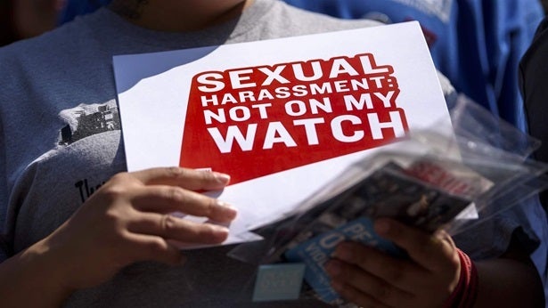 A woman holds a sign at a protest in California. A number of states this year passed legislation to try and stop workplace sexual harassment.