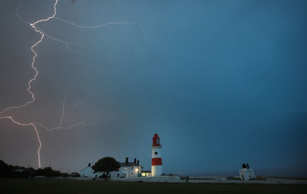 Lightning flashes over Souter lighthouse in South Shields as heavy thunderstorms marked the end of the UK heatwave on Friday.