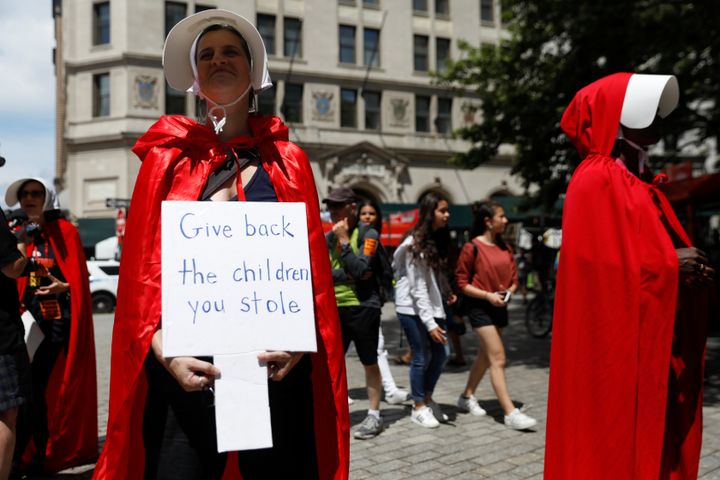 Women dressed in handmaids outfits protest Vice President Mike Pence and Department of Homeland Security Secretary Kirstjen Nielsen in New York City on July 31, 2018.
