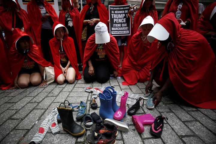 Protesters in "Handmaid's Tale" costumes stage a demonstration in front of the Alexander Hamilton Customs House in New York City on July 31, 2018.