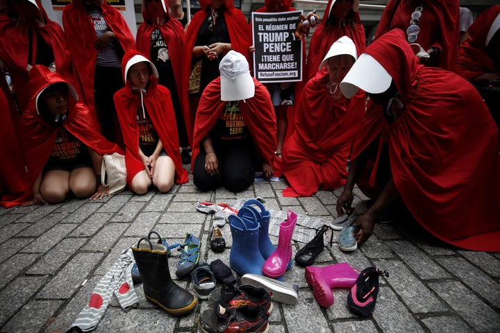 Protesters in "Handmaid's Tale" costumes stage a demonstration in front of the Alexander Hamilton Customs House in New Y