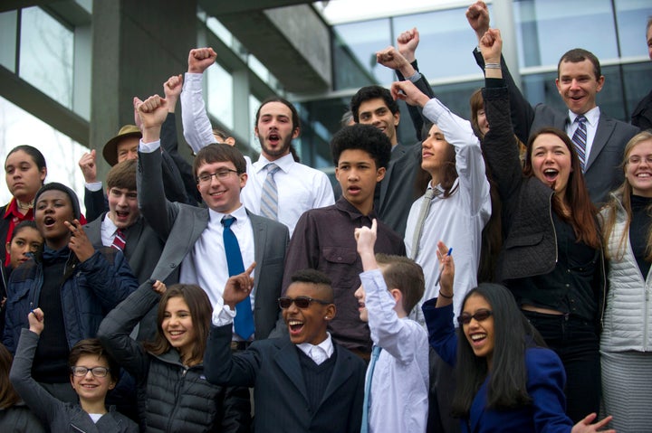 A group of youth plaintiffs cheer after a press briefing outside the federal courthouse in Eugene after a hearing in district