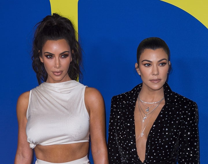 Kim Kardashian (left) and sister Kourtney Kardashian attend the annual Council of Fashion Designers of America awards show this June in New York.