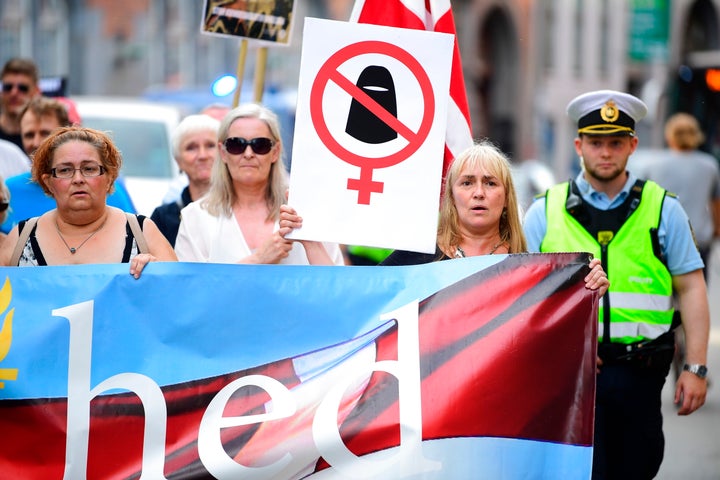 People take part in a demonstration organized by the 'For Frihed' (For Freedom), which supports the face veil ban, on Aug. 1,