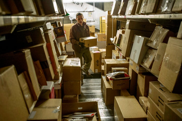 A UPS driver, loads his truck with packages at a UPS sorting facility in San Francisco, California.