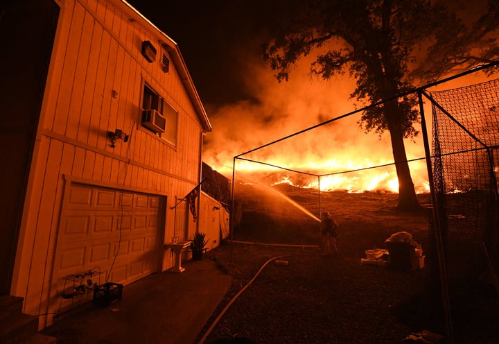 Firefighters conduct a controlled burn to defend houses from the Ranch Fire as it continues to spread toward the town of Upper Lake, California, this week.