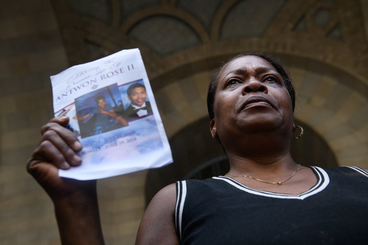 Carmen Ashley, the great aunt of Antwon Rose Jr., cries as she holds the memorial card from Rose's funeral during a June 26 p