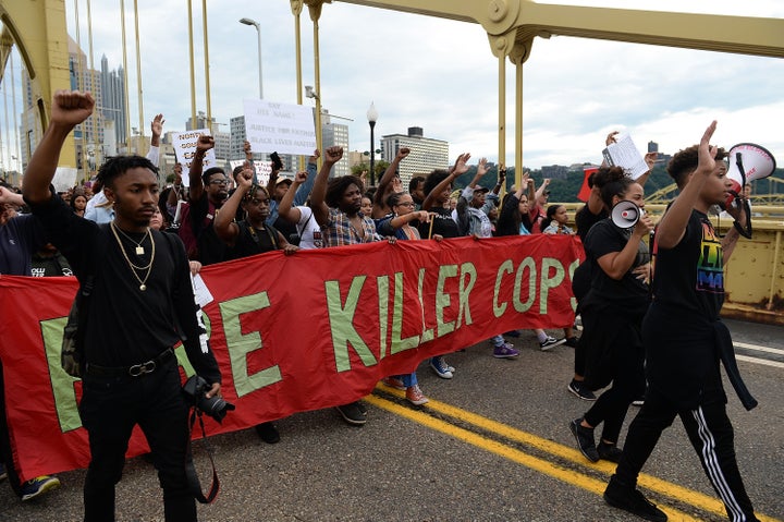 People marching over the Roberto Clemente Bridge in Pittsburgh on June 22, 2018. Demonstrators have protested the fatal shooting of Antwon Rose Jr.