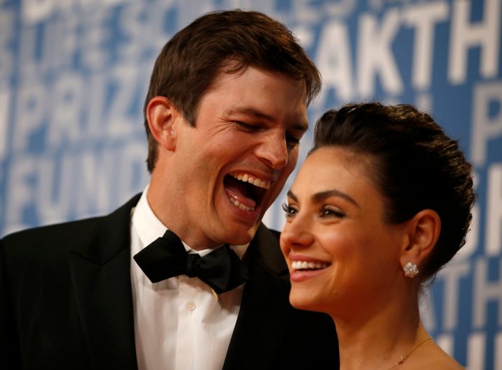 Ashton Kutcher and Mila Kunis while posing for pictures on the red carpet for the 6th annual 2018 Breakthrough Prizes.