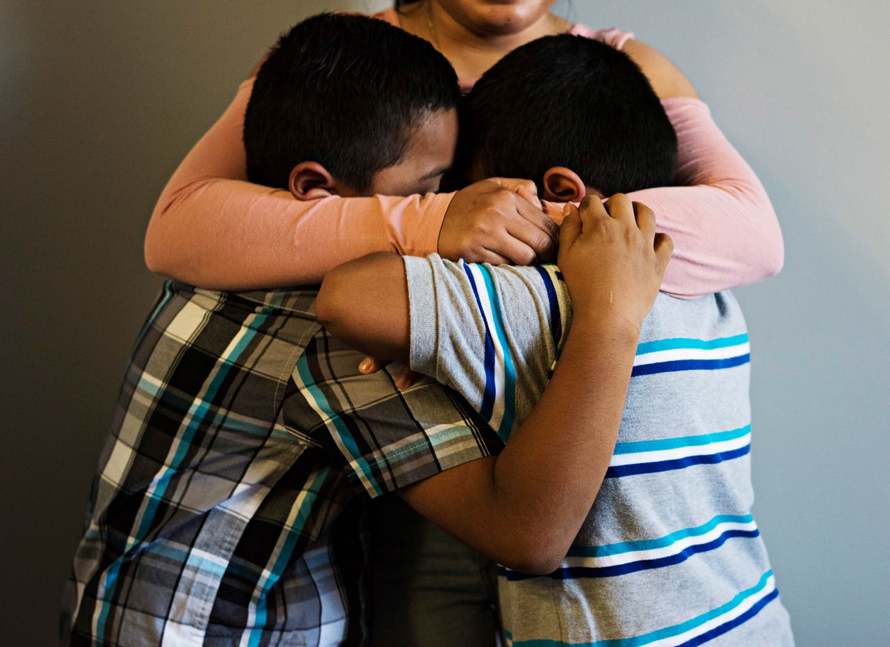 Jorge and Luis get a hug from their aunt Maylin, 20, who came to the United States with them.