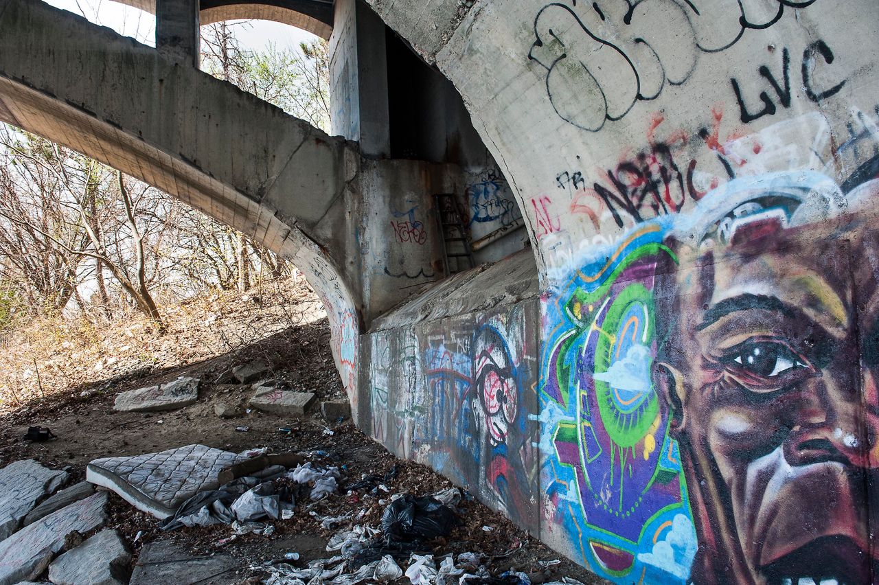 Abandoned homeless encampments dot the edges of the Merrimack River, which cuts through both Lawrence and Lowell. 