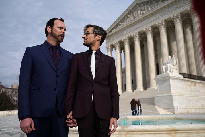 Charlie Craig (left) and Dave Mullins (right), the gay couple who were denied having their wedding cake baked by cake artist Jack Phillips, look at each other during an interview in front of the U.S. Supreme Court on Dec. 5, 2017.