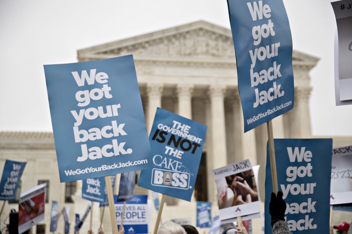 Demonstrators hold signs in support of Masterpiece Cakeshop owner Jack Phillips outside the U.S. Supreme Court on Tuesday, Dec. 5, 2017. 