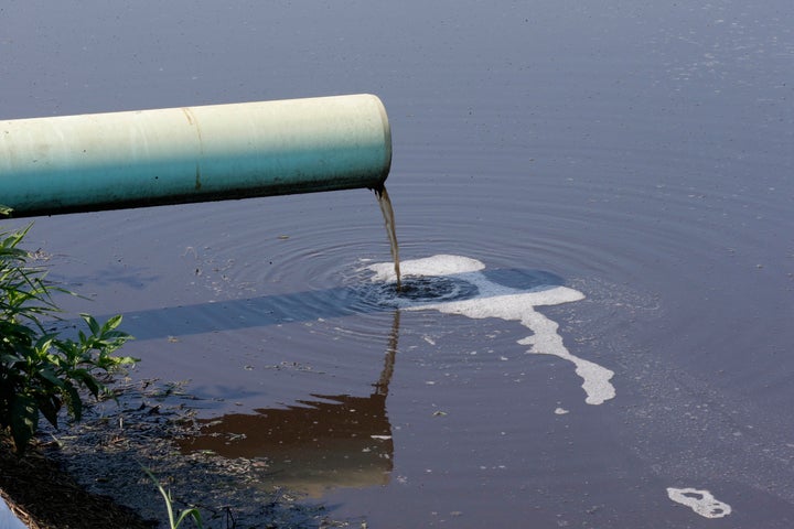 In this July 21, 2017 photo, hog waste flows into the waste pond at a farm that has hogs owned by Smithfield Foods in Farmville, N.C.