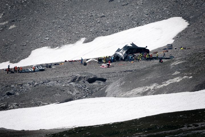 Accident investigators and rescue personnel gather around the wreckage of a Junkers JU52 aircraft at Flims on August 5, 2018, after the plane crashed into Piz Segnas, a 3,000-metre (10,000-foot) peak in eastern Switzerland on August 4. (FABRICE COFFRINI/AFP/Getty Images)