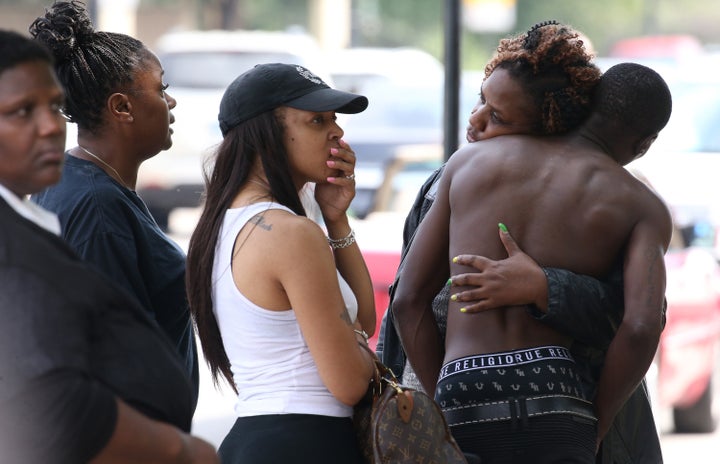 Friends and family members of the shooting victims gathered outside of Stroger Hospital's emergency room after the waiting ar
