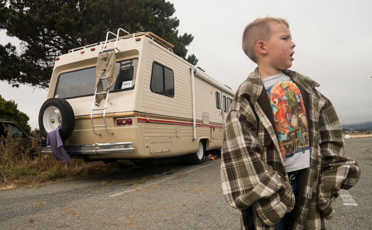Thomas Bockover calls out for his sister while they play with a frisbee near the Berkeley Marina. The Bockover family moved into an RV after their rent price increased.
