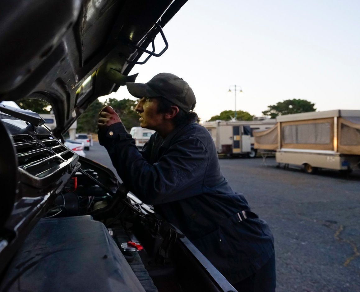 Amber Whitson works on the van she uses to pull her Fleetwood Pace Arrow recreational vehicle.