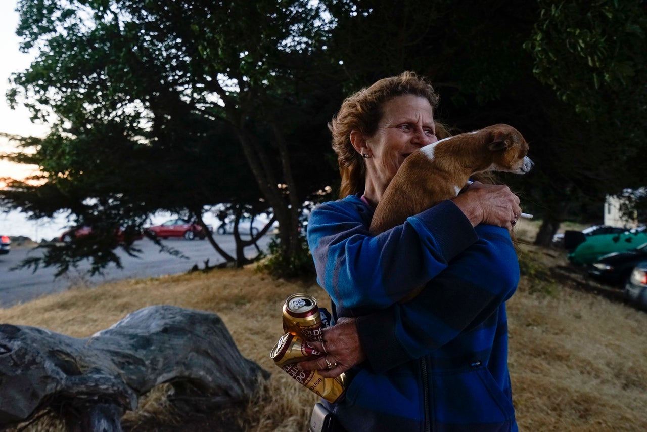 Pamala Benfante, who lives with her cat and three Chihuahua dogs in her 32-foot motorhome, tidies up at a parking lot near the Berkeley Marina.