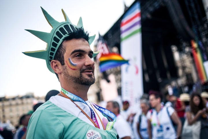 A man wears a cosplay of the Statue of Liberty as attends the inauguration of the sport village of the 2018 Gay Games' editio