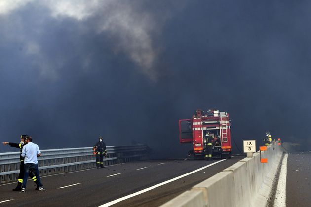 Firefighters work at the scene where the tanker truck exploded.