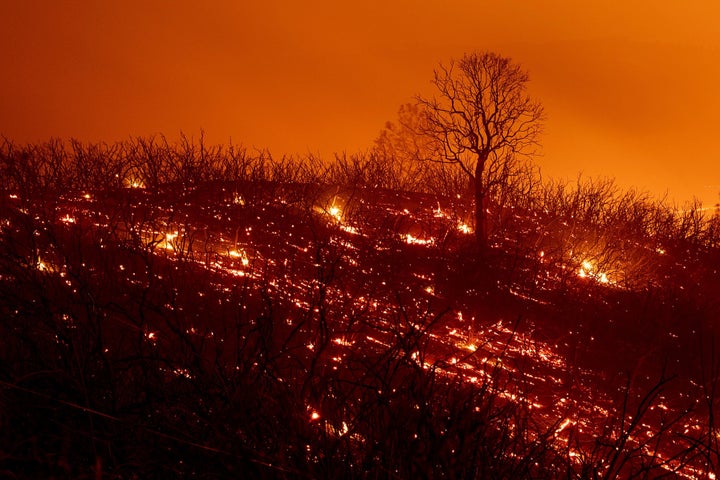 Embers smolder along a hillside after the Ranch Fire, part of the Mendocino Complex Fire, which burned though the area near Clearlake Oaks, California, on Aug. 5, 2018.