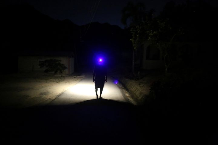 Jose Alvarez, 60, using a headlamp while walking in the dark in Juyaya, Puerto Rico, in May. 