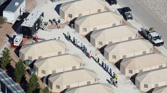 Immigrant children now housed in a tent encampment under the new "zero tolerance" policy by the Trump administration are shown walking in single file at the facility near the Mexican border in Tornillo, Texas, U.S. June 19, 2018.        REUTERS/Mike Blake       TPX IMAGES OF THE DAY