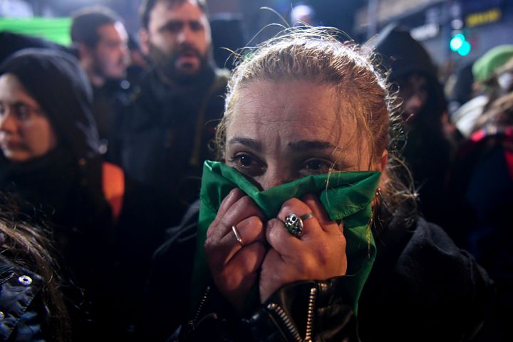 An abortion rights supporter reacts in Buenos Aires after lawmakers rejected the bill to legalize abortion.