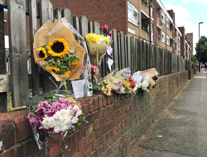 Floral tributes left on a fence near to the scene of the blaze 