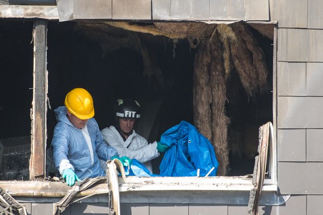 Police and fire investigators at the family home where Joel lost his life 