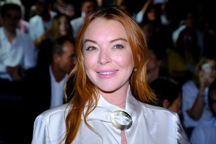 Lindsay Lohan, shown here at Madrid Fashion Week in 2017, said women should file a police report and speak about sexual misconduct when they experience it instead of bringing it up later.
