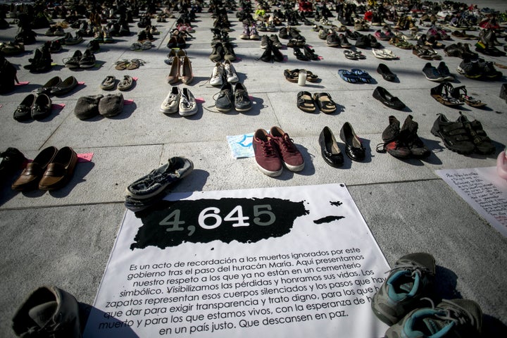 A sign reads '4,645' near empty pairs of shoes outside San Juan's Capitol building during a June protest against the government's reporting of the death toll from Hurricane Maria.