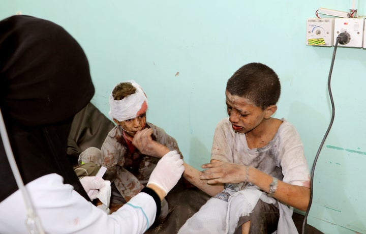 A doctor treats children injured by an airstrike in Saada, Yemen August 9, 2018.