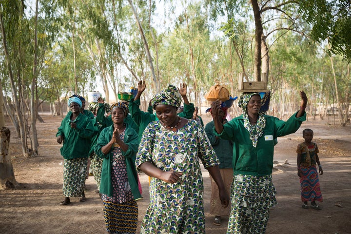 “As the group we consider ourselves as one single family; as sisters, as mothers-in-law, as daughters-in-law as friends, sometimes there might be problems which is quite normal in any group, but this is not really that normal, we consider ourselves as one group, a single family.” Ruth Diallo, centre, president of women-led soap and shea butter-making collective. Women from Samabogo gather together to make shea butter under the shade of trees.