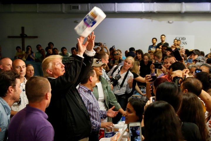 President Donald Trump throws paper towels to Puerto Ricans while visiting a church in San Juan on Oct. 3, days after Hurricane Maria battered the island.