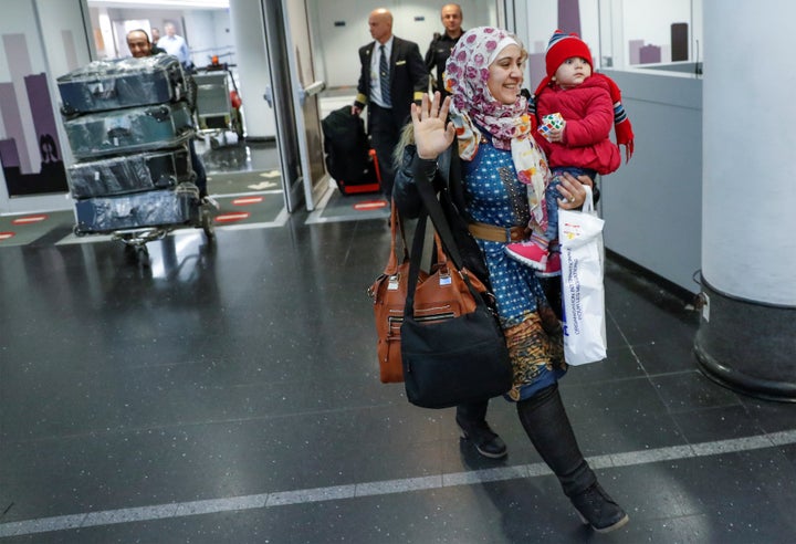 Syrian refugee Baraa Haj Khalaf, her daughter Shams, 1, and husband Abdulmajeed arrive at O'Hare International Airport in Chi