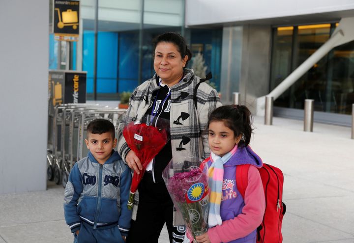 Iraqi refugee Amira Al-Qassab stands outside with two of her children as a relative picks them up at Detroit Metro Airport in Romulus, Michigan, on Feb. 10, 2017.