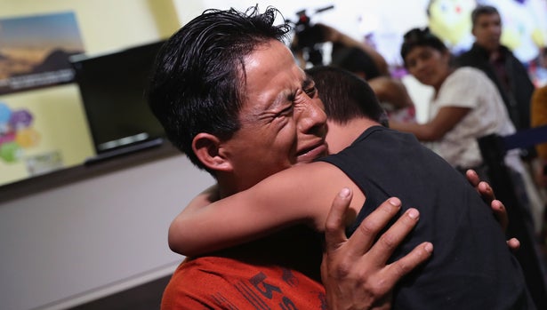 GUATEMALA CITY, GUATEMALA - AUGUST 07:  An emotional father embraces his son for the first time in months on August 7, 2018 in Guatemala City, Guatemala. A group of nine children were flown from New York and reunited with their families, months after U.S. border agents separated them and deported the parents as part of the Trump administration's 'zero tolerance' policy at the border. Some of the children had been held at the Cayuga Center in New York City.  (Photo by John Moore/Getty Images)