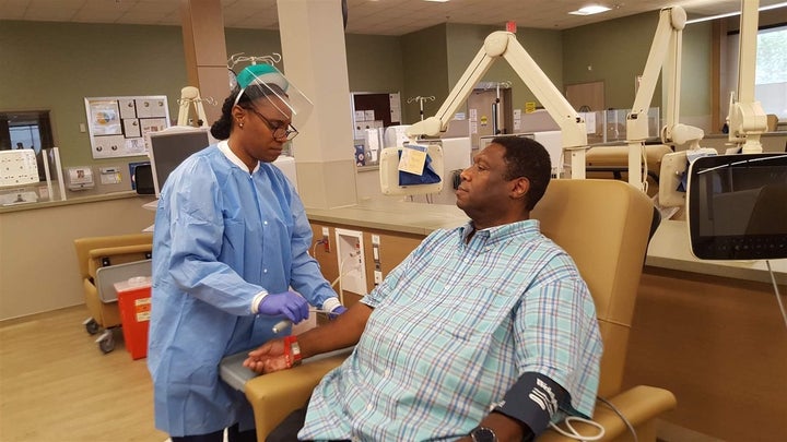 Dialysis technician Audrey Thomas demonstrates how kidney dialysis is set up on patient DeWayne Cox at a new Southern Califor