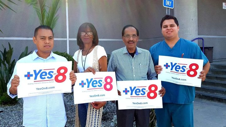 Dialysis technician Emerson Padua, left, patients Tangi Foster and Amar Bajwa, and technician Emanuel Gonzales, right, demonstrate their support of California’s Proposition 8, a ballot measure that would limit clinic profits. They hope the measure, if approved, will lead to higher wages and better clinic conditions.