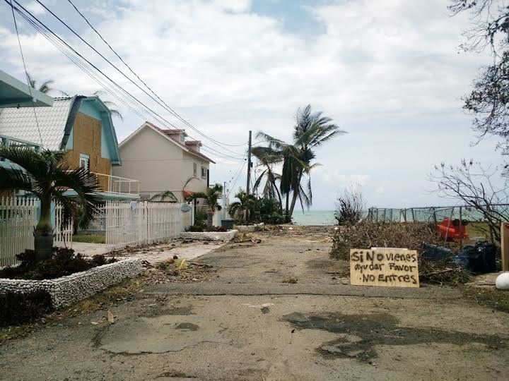 Tres Sirenas hotel, owned by Wanda Acosta and her partner, in Rincón, Puerto Rico, the morning Hurricane Maria made landfall in September. "If you're not here to help, please do not enter," reads a sign on the street.