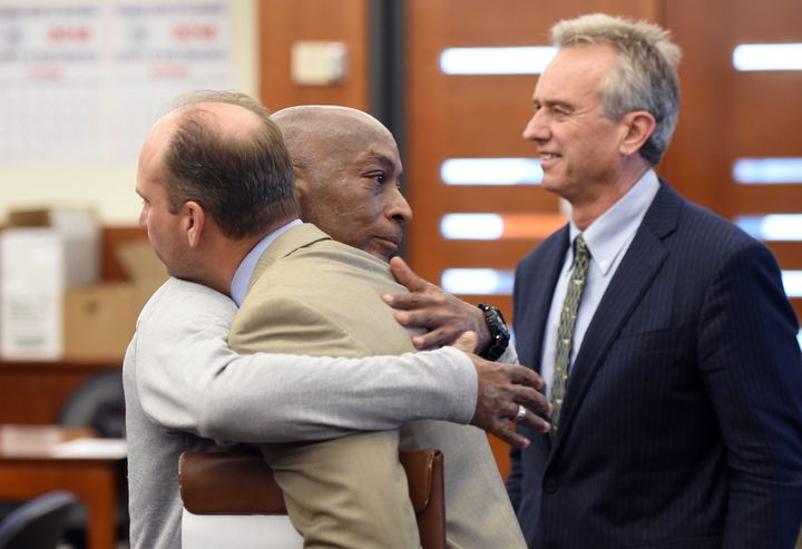 Johnson hugs one of his attorneys after the verdict was read out
