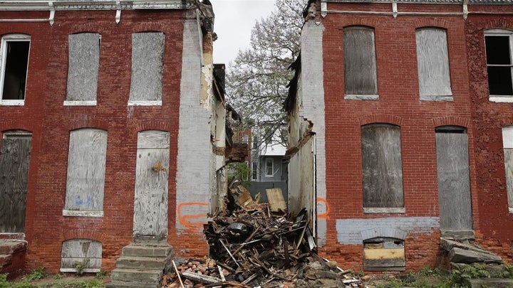 Debris remains where a demolished rowhouse once stood on one of many blocks slated for demolition in Baltimore. When possible, city officials want to dismantle and salvage materials from buildings rather than demolishing them. 