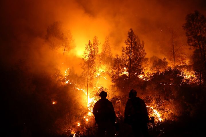 Firefighters monitor a back fire as they battle the Medocino Complex fire on August 7, 2018 near Lodoga, California.