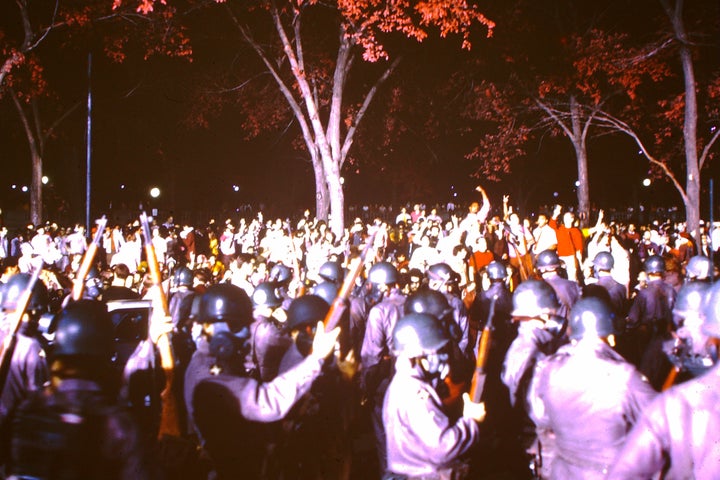 Police officers and National Guardsmen face protesters outside the 1968 Democratic National Convention in Chicago.