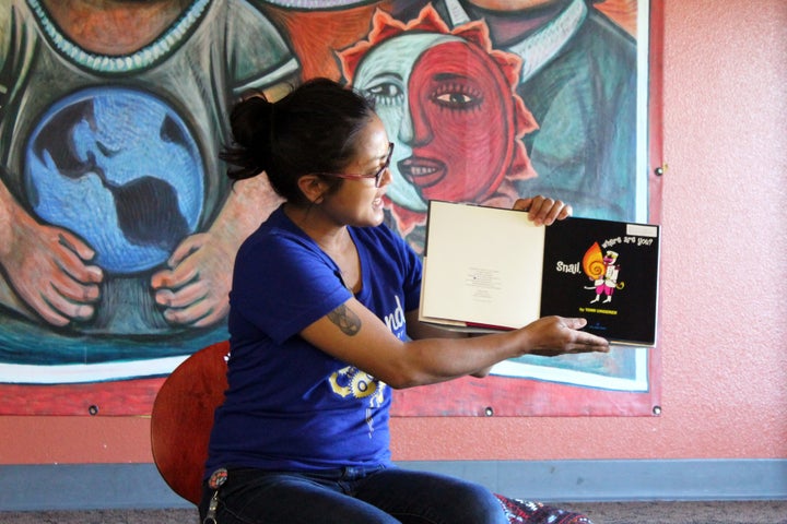 Children's librarian Annabelle Blackman reads a book titled, Snail, Where Are You? during her summer storytime at Cesar Chavez Public Library in Oakland, Calif.